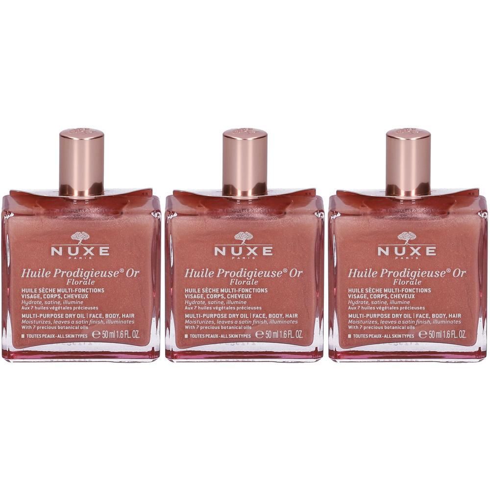 Tre flaconi di Nuxe Huile Prodigieuse Or Florale con pagliuzze dorate.