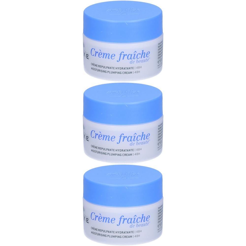 Tre vasetti di crema idratante NUXE Crème fraîche de beauté con tappi blu.