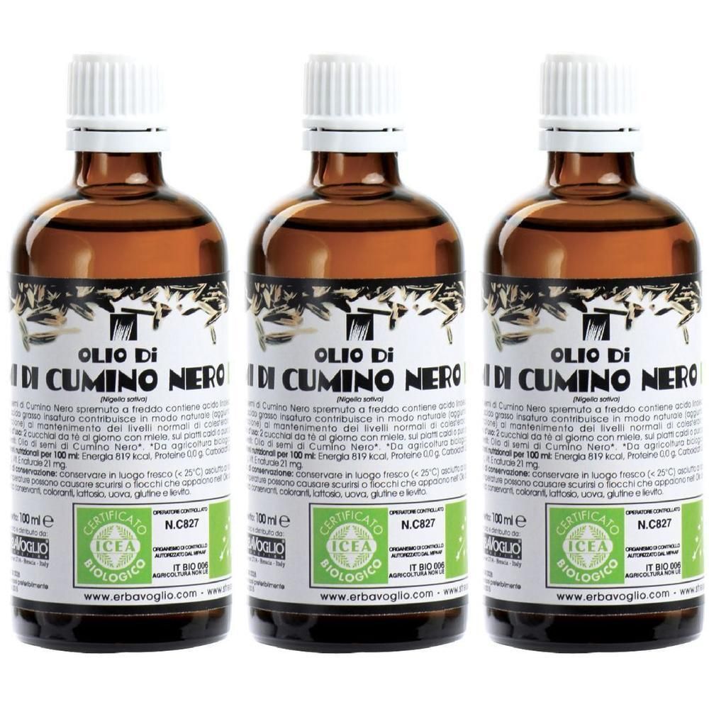 Tre bottiglie di olio di cumino nero biologico con tappi ed etichette bianchi.
