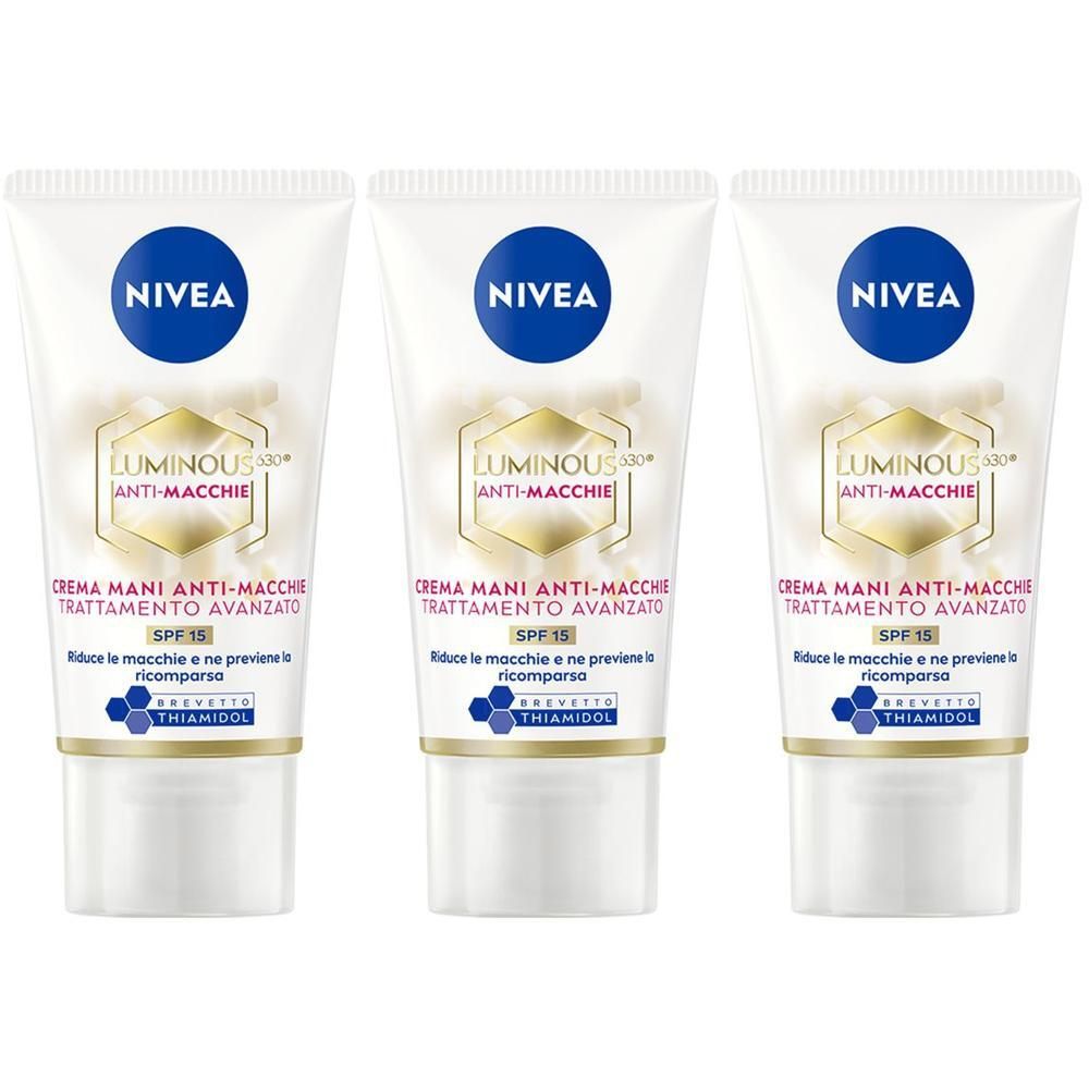 Tre tubi di crema mani Nivea Luminous630 con SPF 15. Tubi bianchi con logo Nivea blu e scritte dorate.