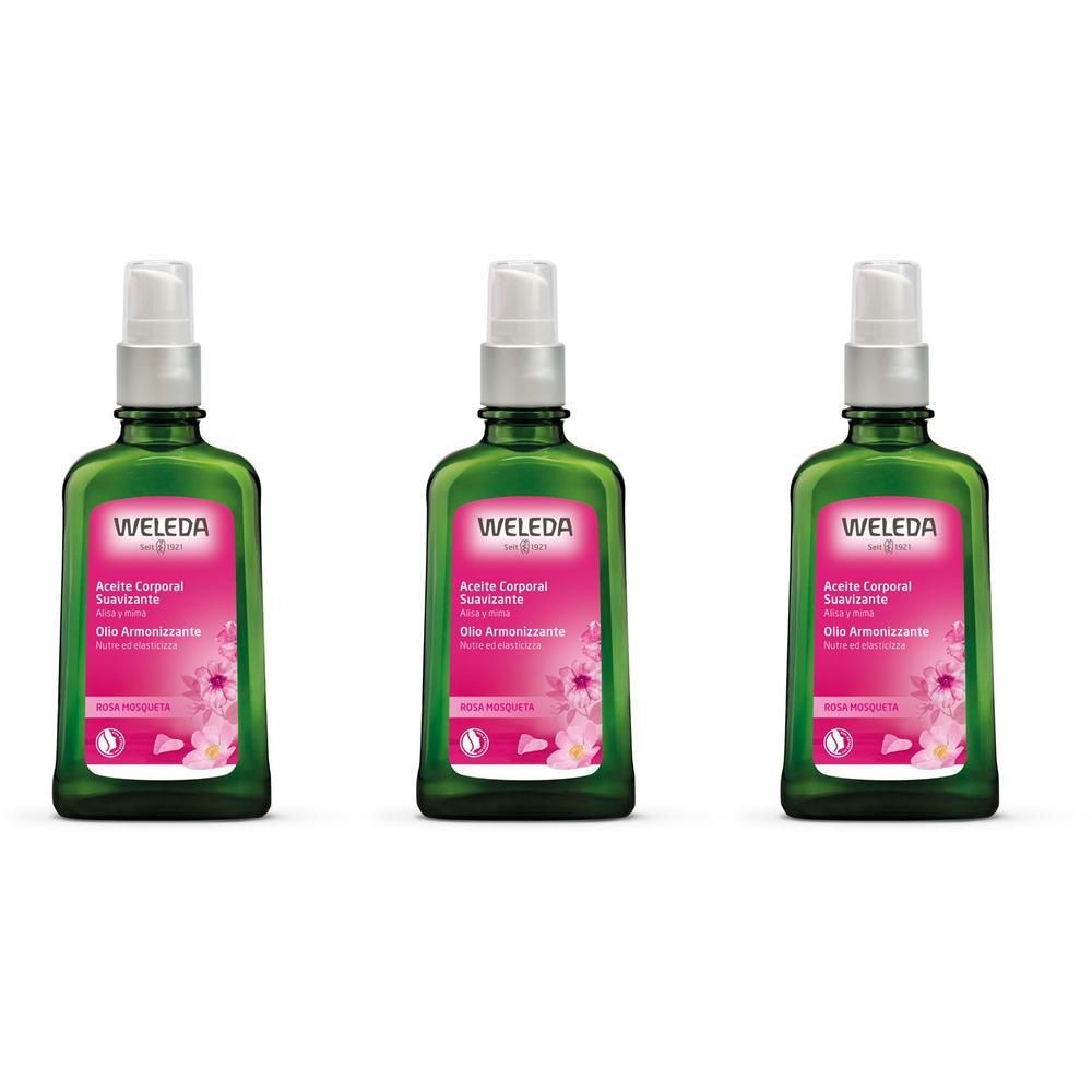 Tre flaconi in vetro verde con erogatore a pompa ed etichetta rosa con motivo floreale.