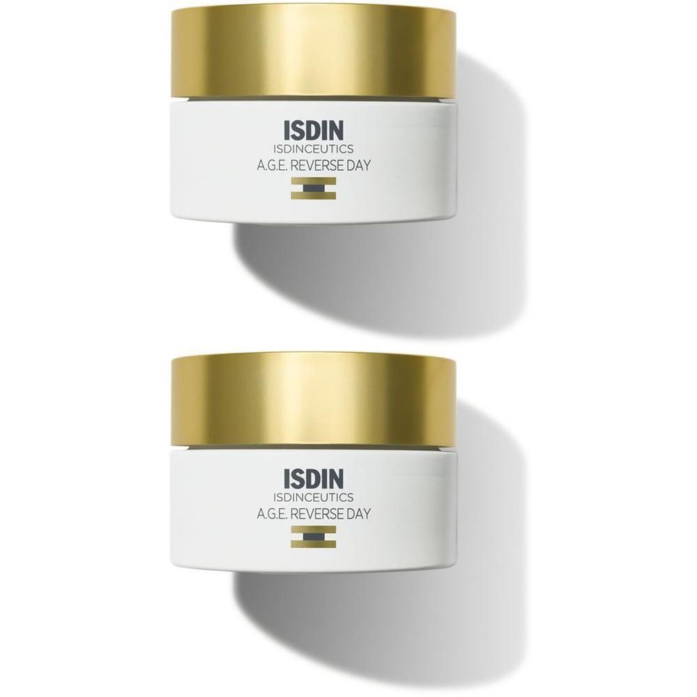 Due vasetti di crema ISDIN Isdinceutics AGE Reverse Day con tappi dorati.