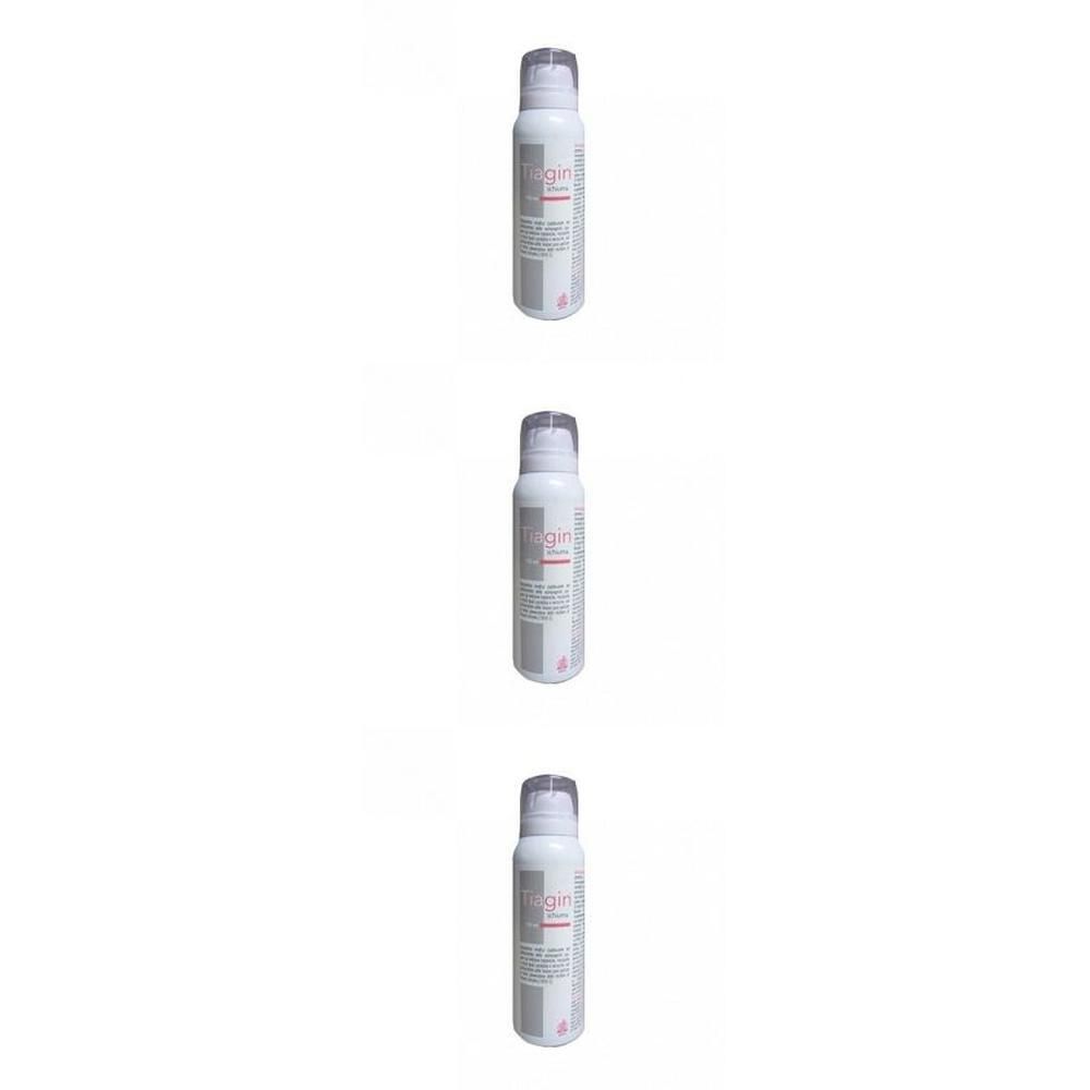 Tre bombolette spray bianche con etichette rosa e grigie.
