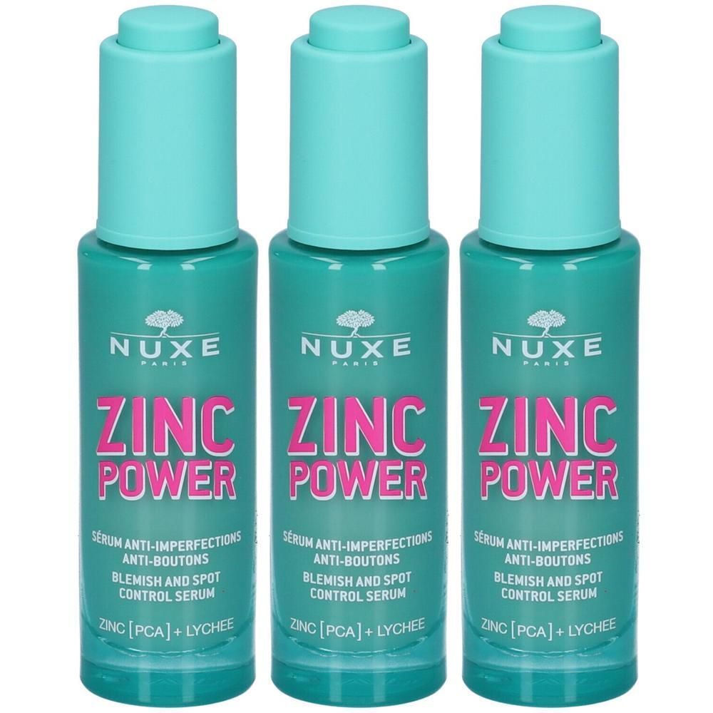 Tre sieri Nuxe Zinc Power con dosatori a pompa. Flaconi color turchese con scritte rosa e bianche.
