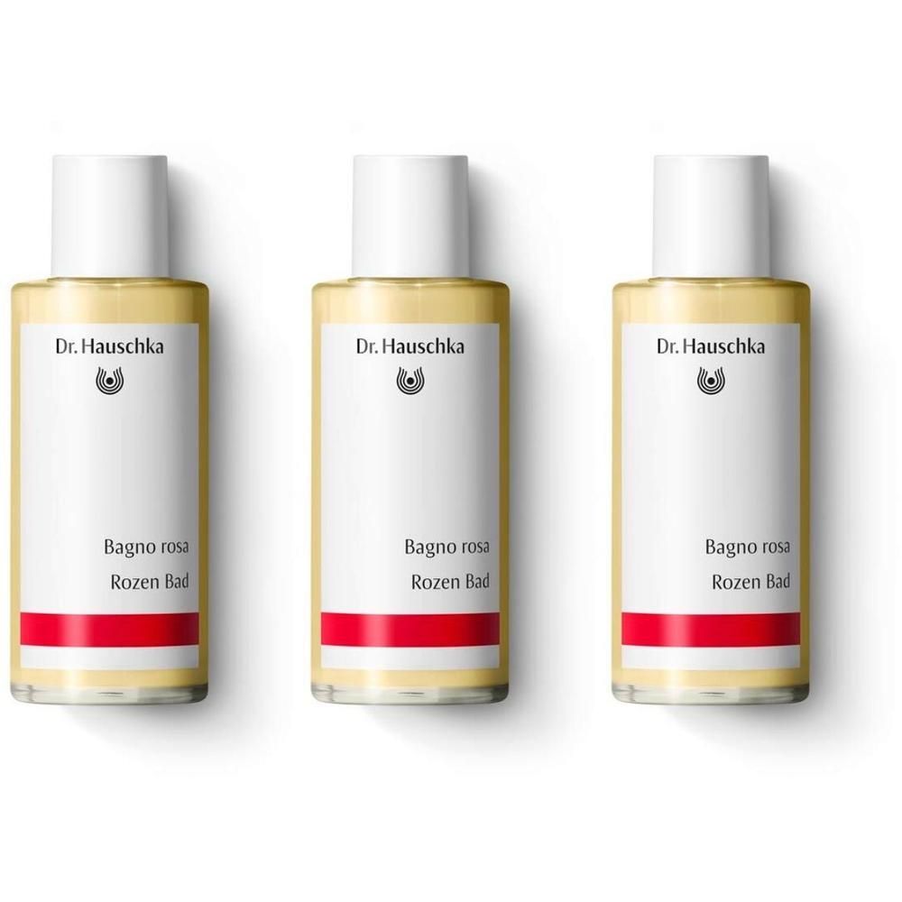 Tre flaconi di bagnoschiuma rosa Dr. Hauschka con tappo bianco ed etichetta.