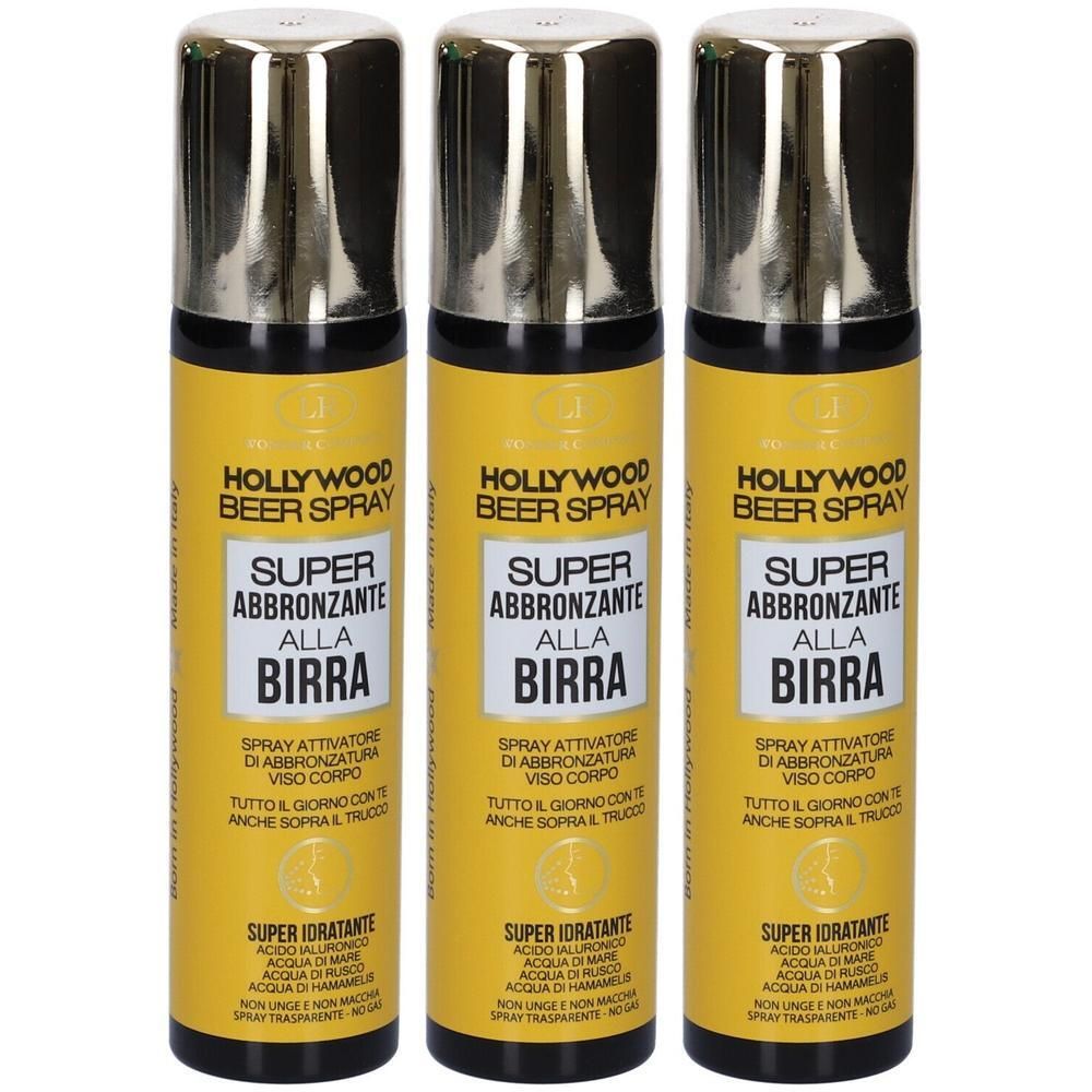 Tre flaconi spray con tappi dorati, etichetta gialla e testo nero. Scritta: "HOLLYWOOD BEER SPRAY SUPER ABBRONZANTE ALLA BIRRA".