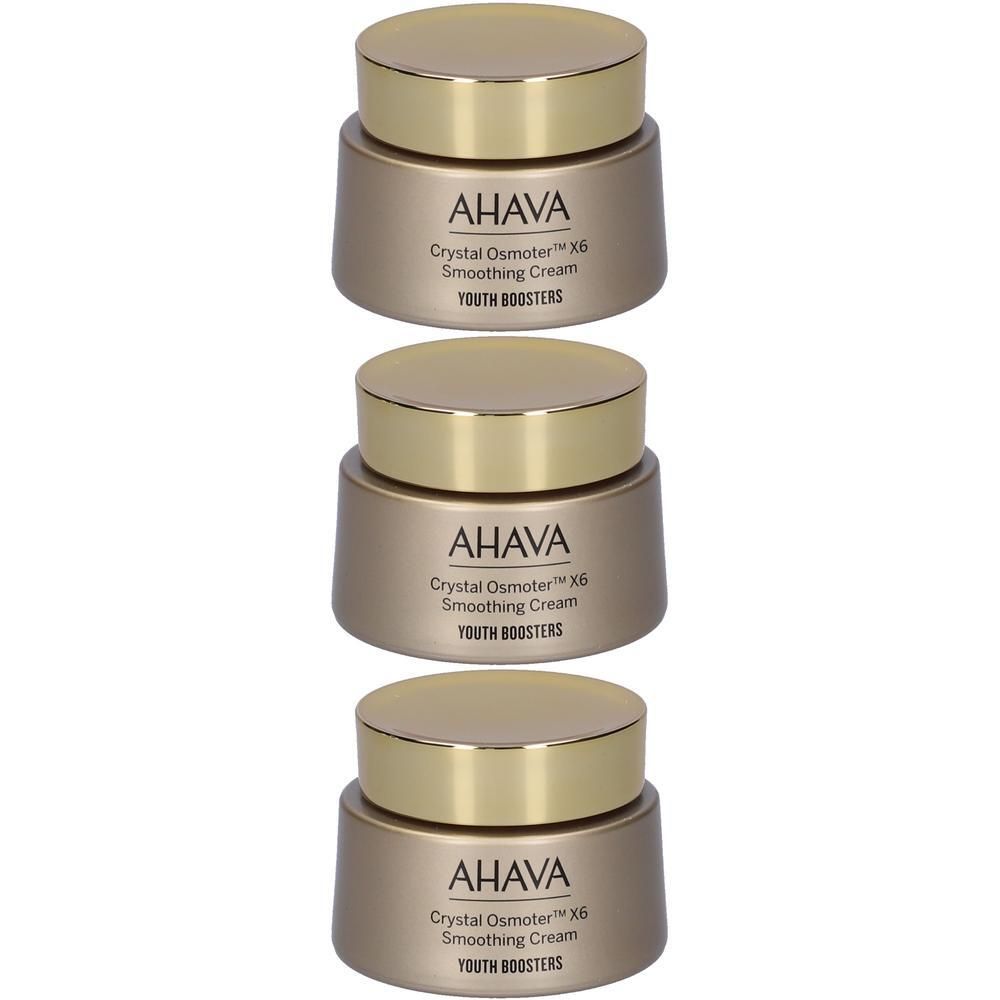 Tre vasetti di crema AHAVA con tappi dorati. Contenitori lisci e dorati con scritte.