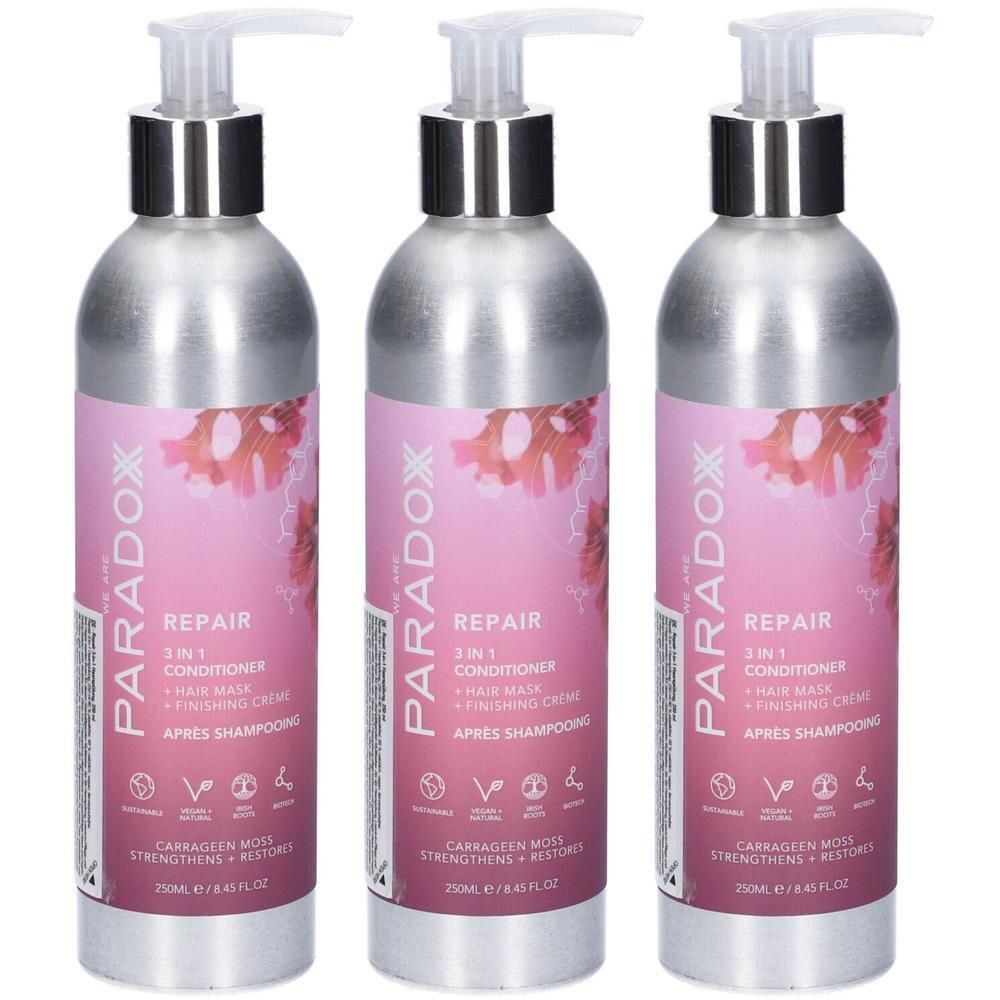 Tre flaconi argentati con pompa ed etichetta rosa per PARADOX REPAIR Balsamo 3 in 1.