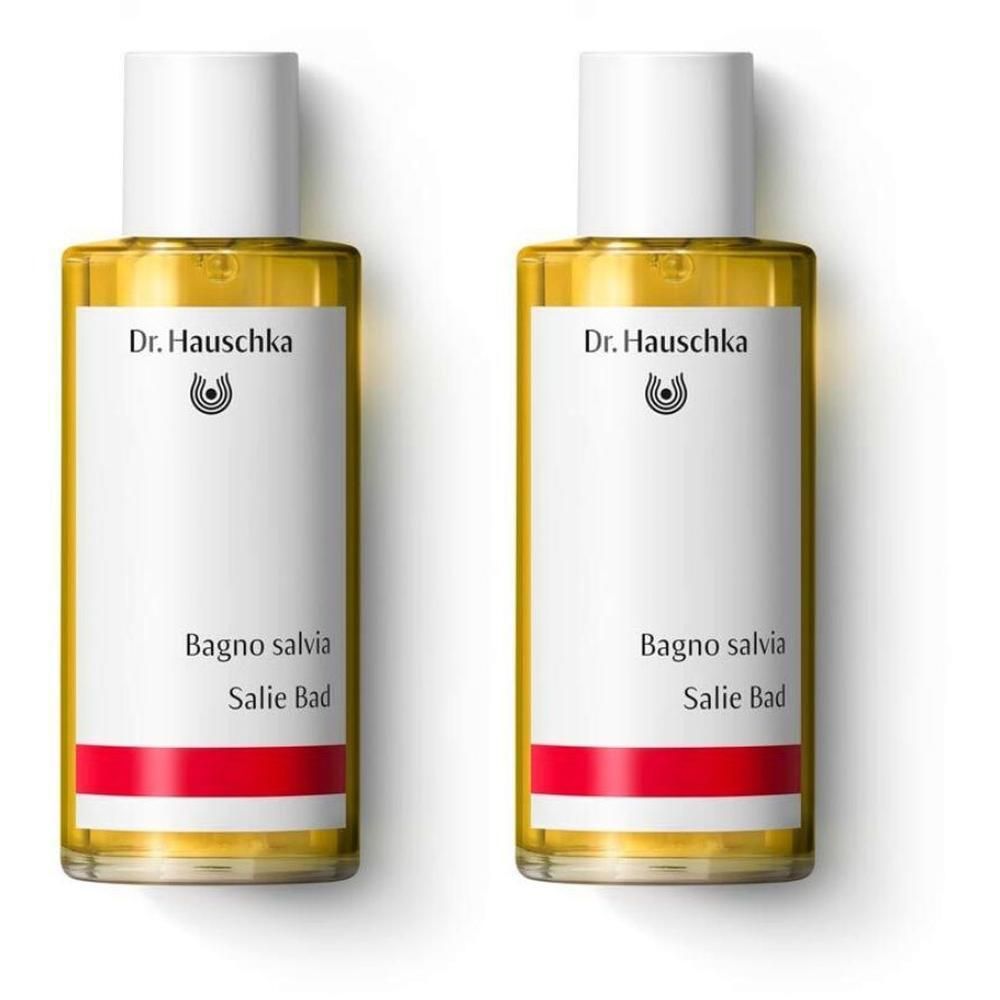 Due flaconi di bagno alla salvia Dr. Hauschka con liquido giallo ed etichetta bianca.