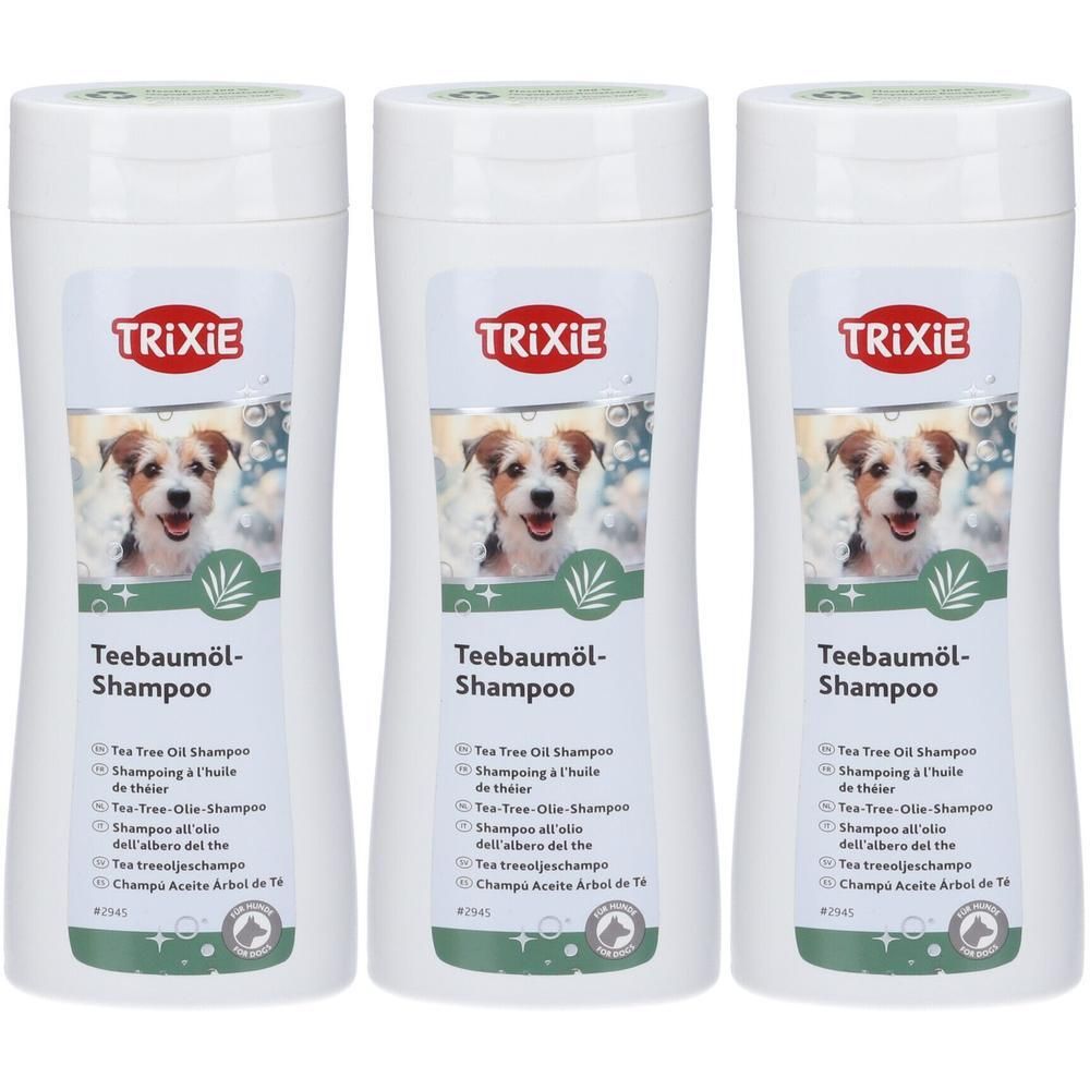 Tre flaconi di shampoo Trixie all'olio di tea tree con immagine di cane e foglia di bambù.