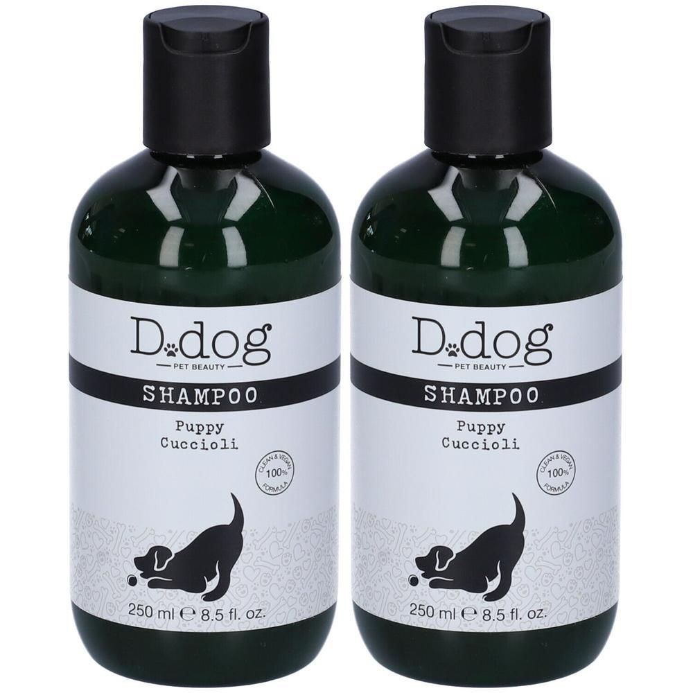 Due flaconi di shampoo D.dog per cuccioli in contenitori verde scuro con tappi neri.