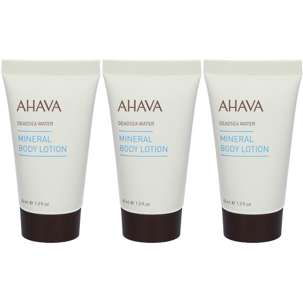 Tre tubetti di AHAVA Mineral Body Lotion con tappo marrone.
