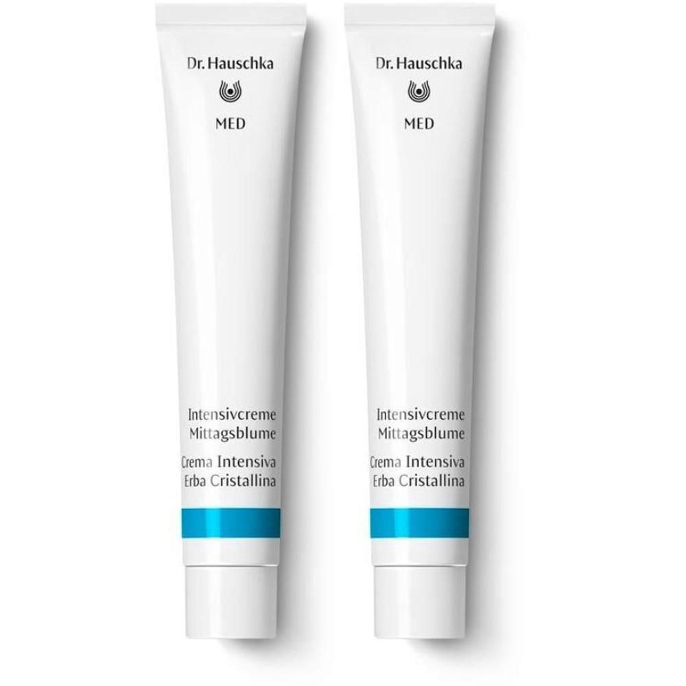 Due tubetti bianchi di Crema Intensiva Erba Cristallina Dr. Hauschka con accenti blu.
