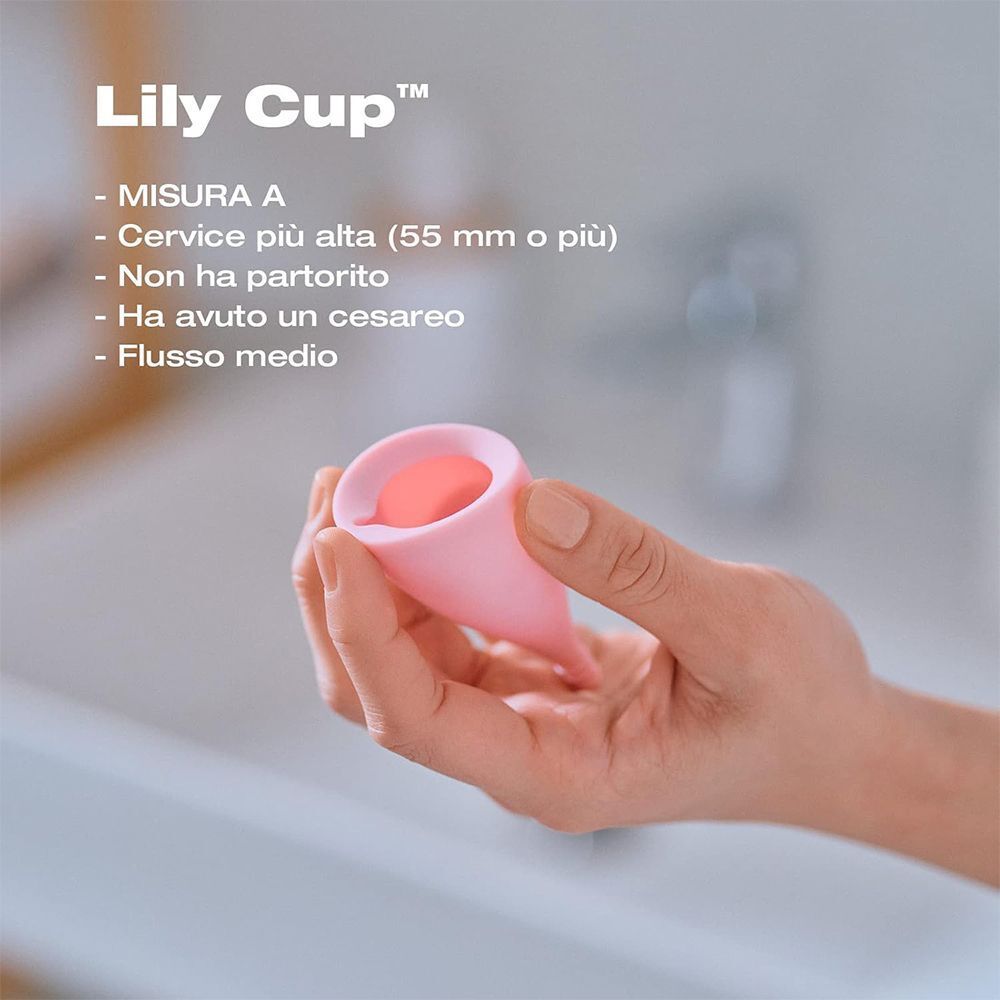 Mano che tiene una coppetta mestruale rosa.