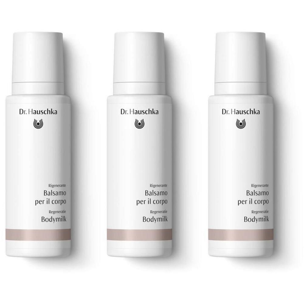 Tre flaconi bianchi Dr. Hauschka Balsamo Rigenerante Corpo con fascia.