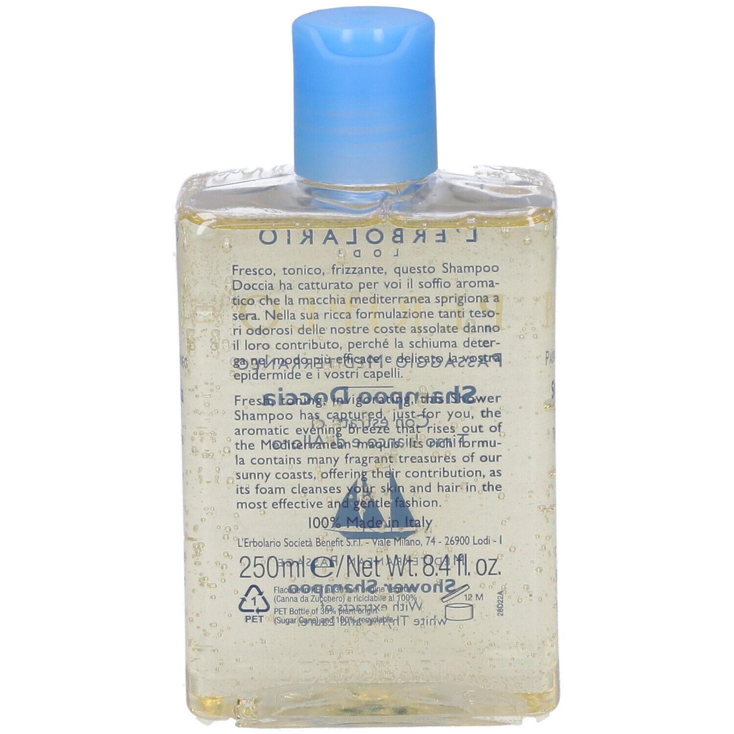 Retro del flacone trasparente. Testo: Shampoo Doccia, ingredienti e informazioni sul prodotto. Etichetta blu.