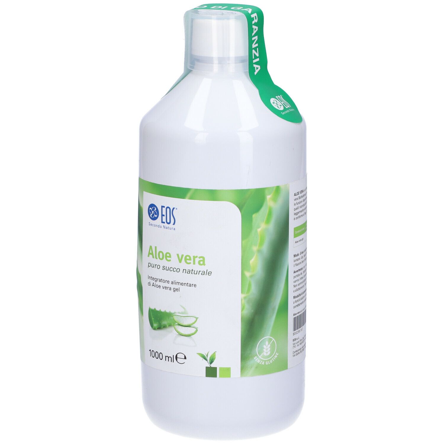 Bottiglia bianca con etichetta verde. Scritta: Aloe vera, logo. Sigillo sul collo.