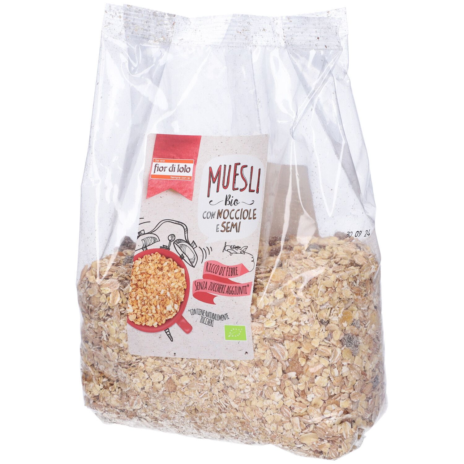 Sacchetto trasparente di muesli. Etichetta 'Muesli Bio con Nocciole e Semi'. Contiene nocciole e semi.