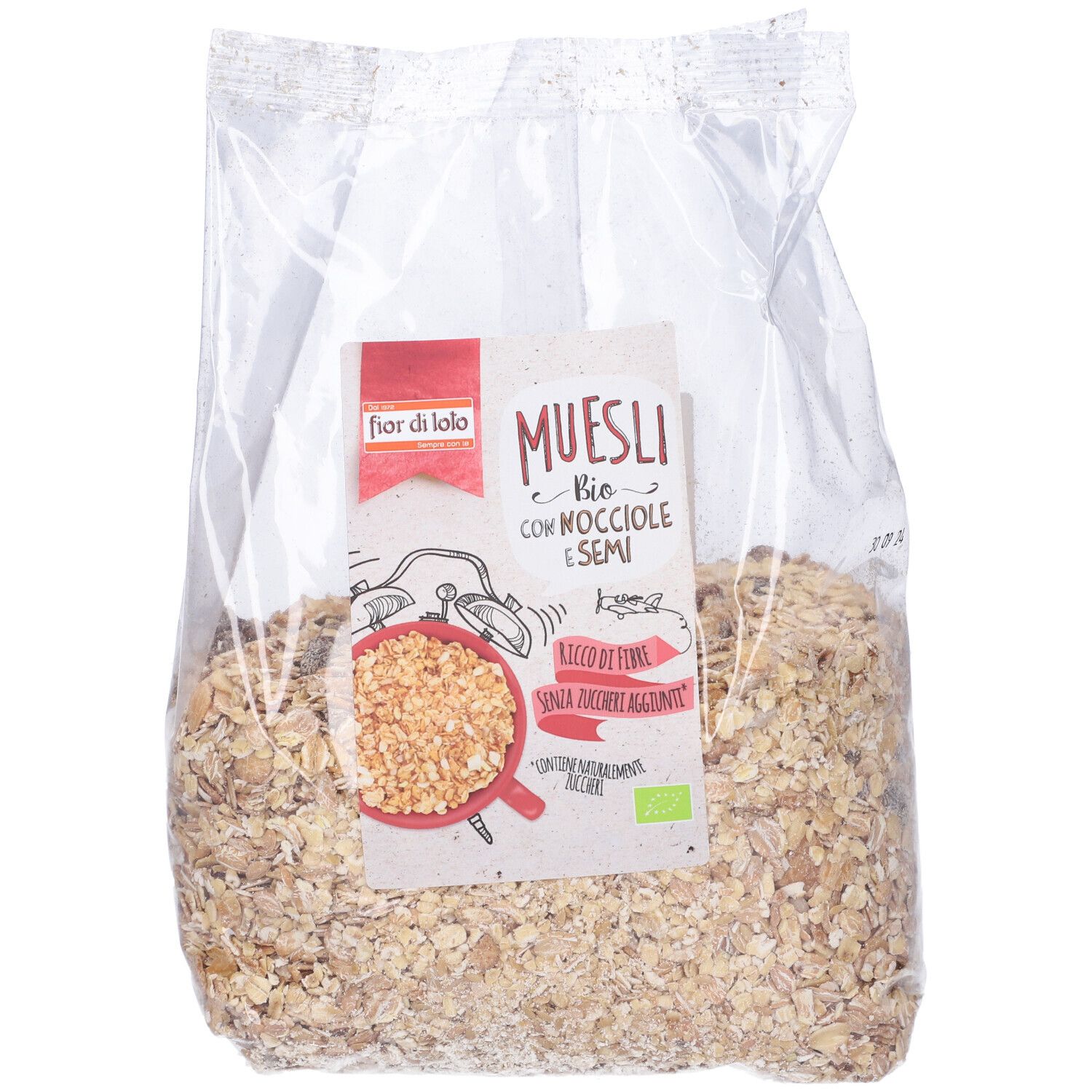 Sacchetto trasparente di muesli. Etichetta 'Muesli Bio con Nocciole e Semi'. Contiene nocciole e semi.