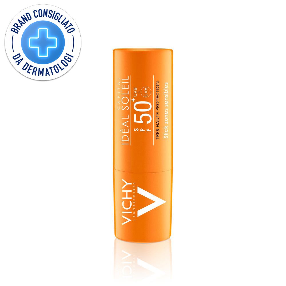 Stick solare arancione con SPF 50+. Logo Vichy e sigillo dermatologico. Testo: Ideal Soleil, Très Haute Protection.
