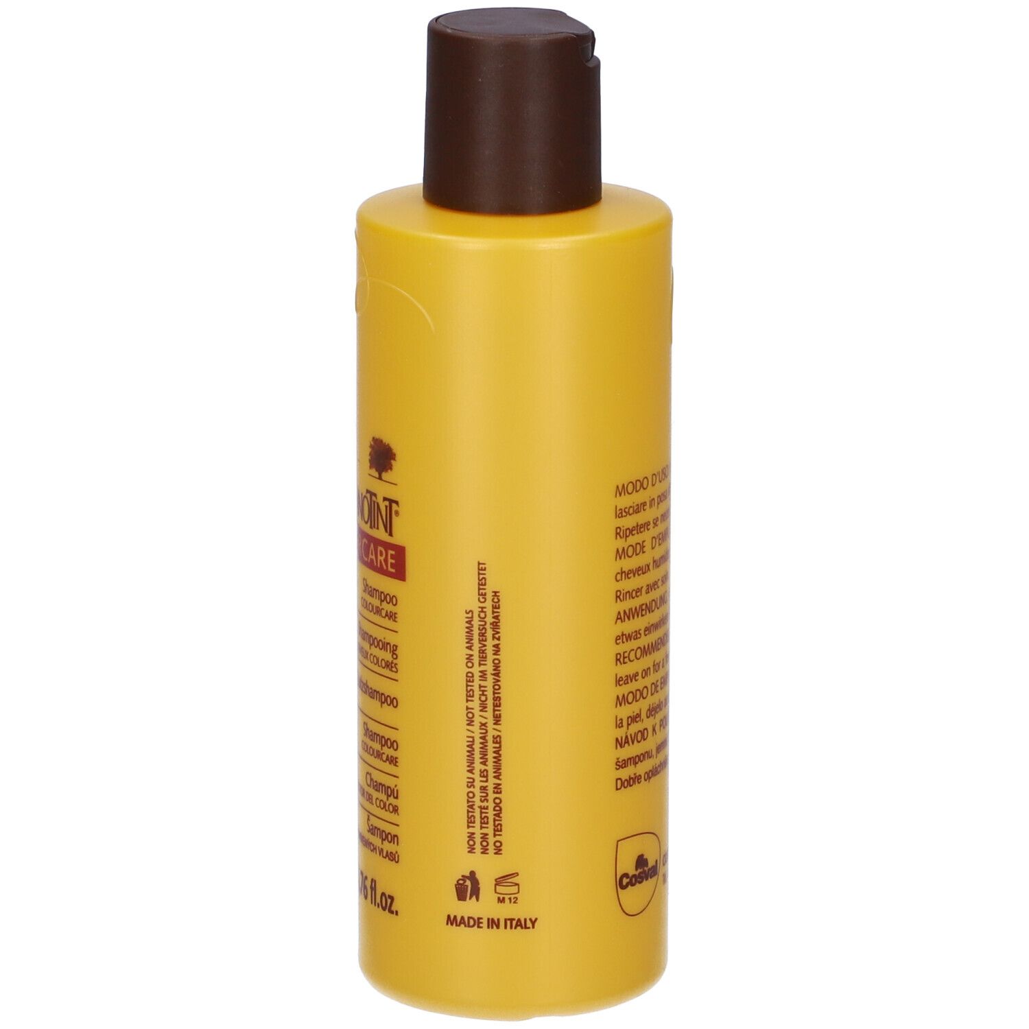 Retro di un flacone di shampoo giallo con tappo marrone. Testo multilingue.