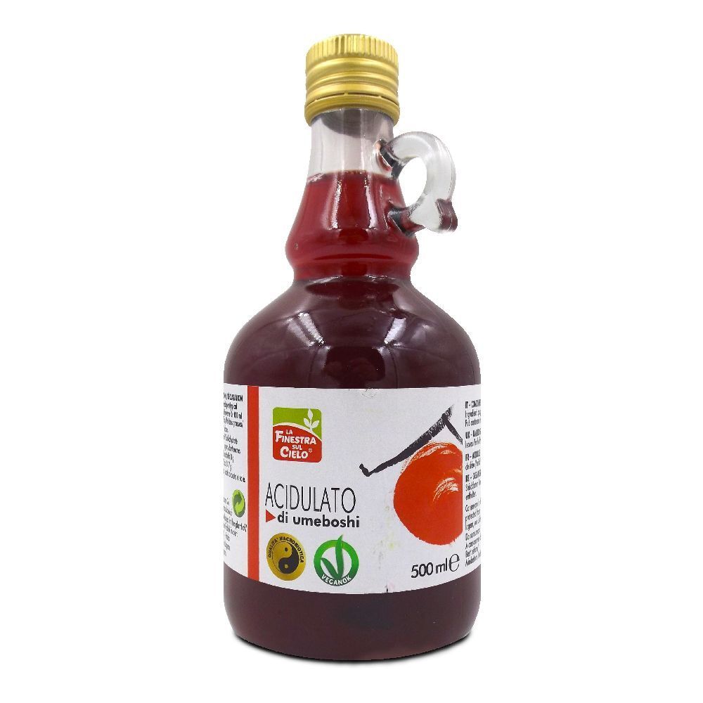 Bottiglia di vetro con liquido rosso. Scritta: Acidulato di Umeboshi. 500ml. Con manico.