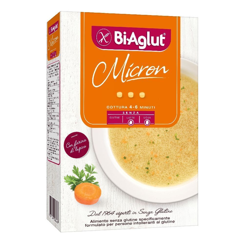 Confezione Biaglut Micron. Sfondo arancione con nome prodotto e immagine zuppa. Contiene carote e prezzemolo.