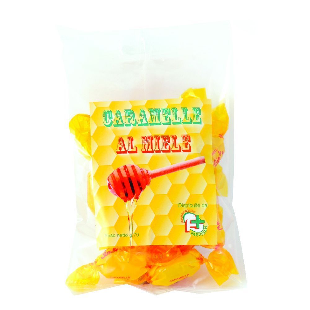 Confezione trasparente con caramelle gialle. Etichetta con scritta "Caramelle al Miele" e disegno di cucchiaio di miele.