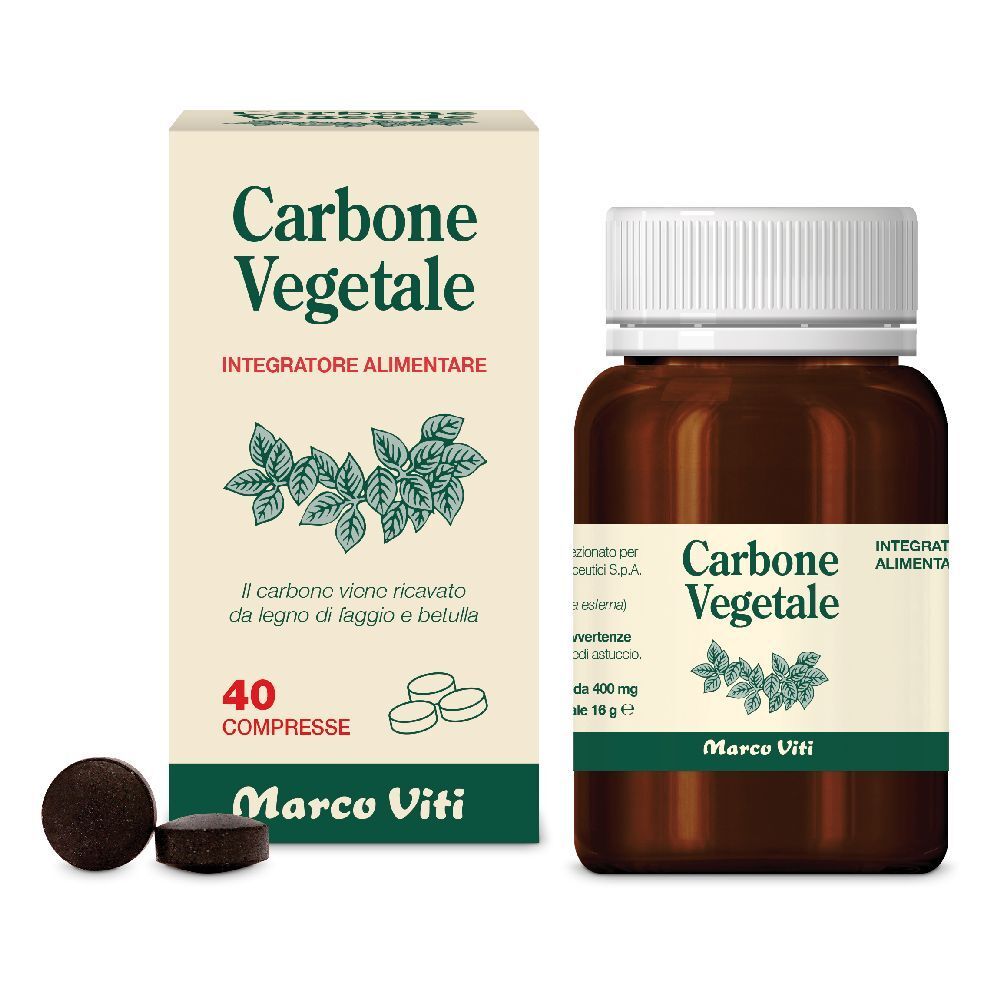 Compresse marroni e flacone di compresse. Il flacone riporta "Carbone Vegetale".