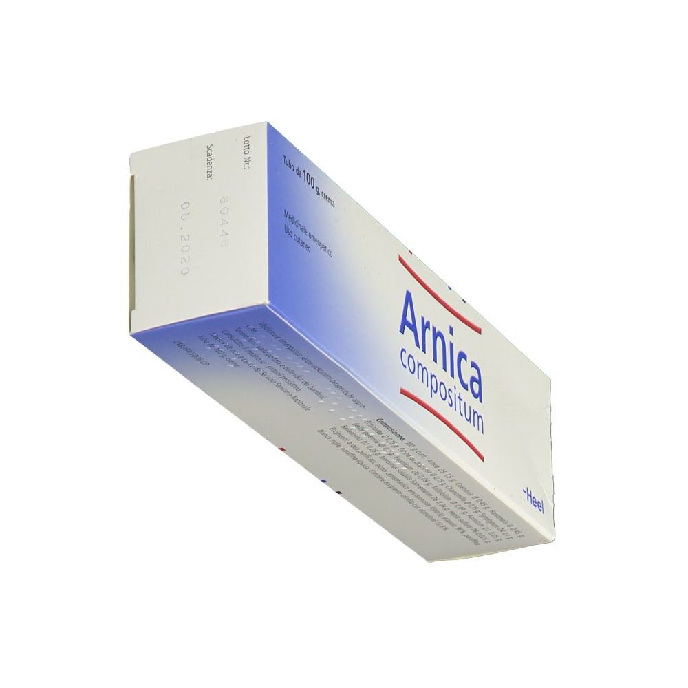 Scatola bianca con sfumatura blu. Scritto: Arnica compositum. Marchio: Heel. Scritta rossa e blu. Testo sulla confezione.