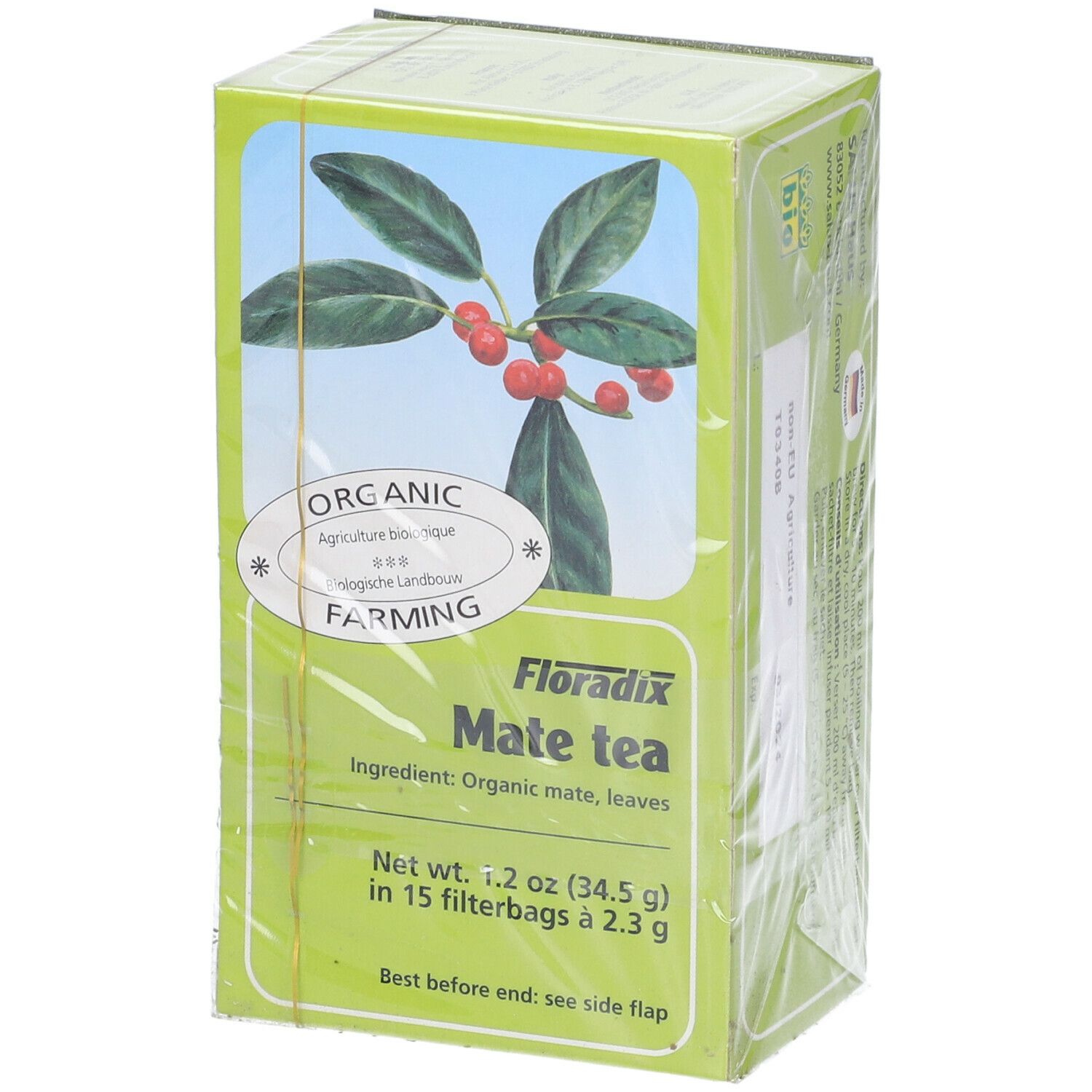 Scatola verde Mate Tea. Scritto: Organic Farming, Mate Tea, 15 bustine filtro. Illustrazione di foglie e bacche rosse. Marchio bio.