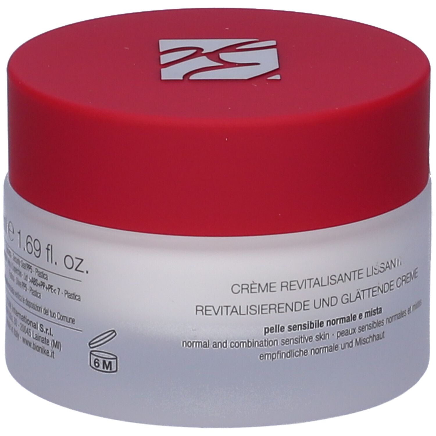 Creme-Glas mit rotem Deckel. Aufschrift: Creme Revitalisierende und Glättende Creme. 1.69 fl. oz. Weißes Glas, roter Deckel.