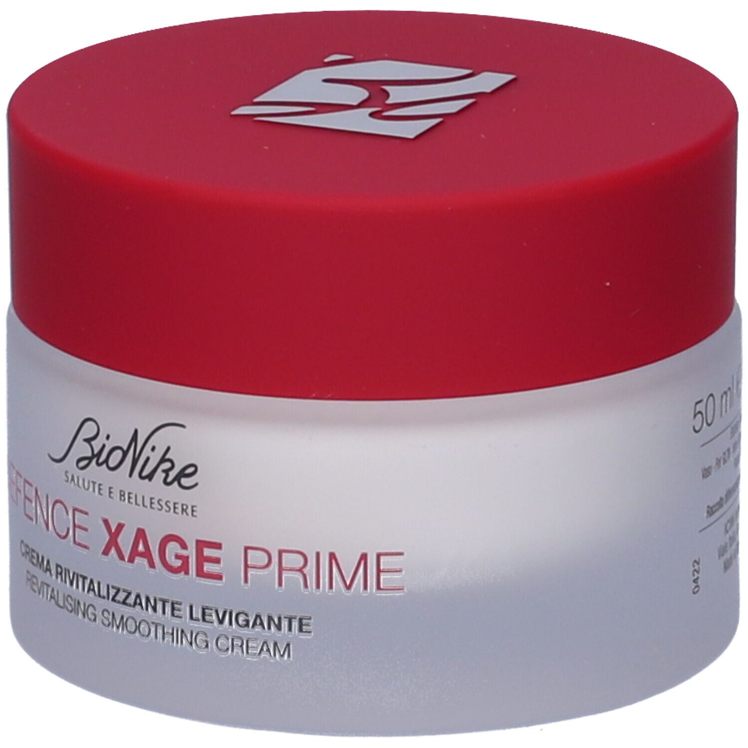 Creme-Glas mit rotem Deckel. Aufschrift: BioNike, Defence Xage Prime, Creme Revitalisante Levigante. 50 ml. Weißes Glas, roter Deckel.