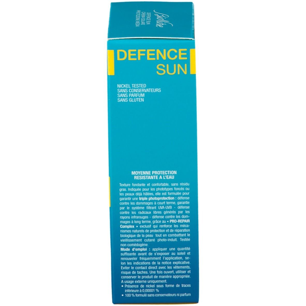 Côté de la boîte de crème solaire. Texte: Protection moyenne, résistant à l'eau. Ingrédients et instructions. Testé au nickel, sans parfum ni gluten.