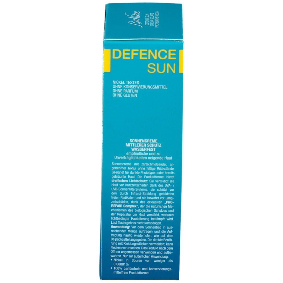 Côté de la boîte de crème solaire. Texte: Protection moyenne, résistant à l'eau. Ingrédients et instructions. Testé au nickel, sans parfum ni gluten.