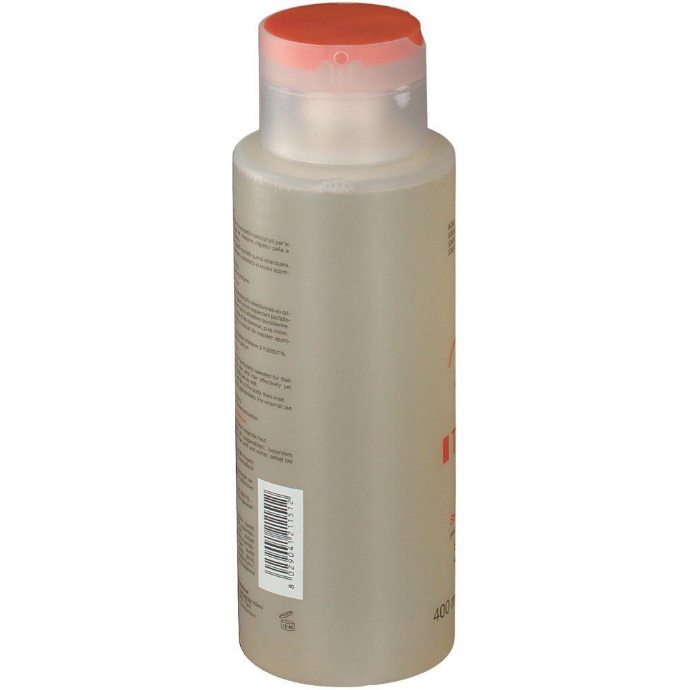 BioNike Triderm Dusch-Shampoo. Flacone, vista laterale. Etichetta con codice a barre. Liquido trasparente. Tappo arancione.