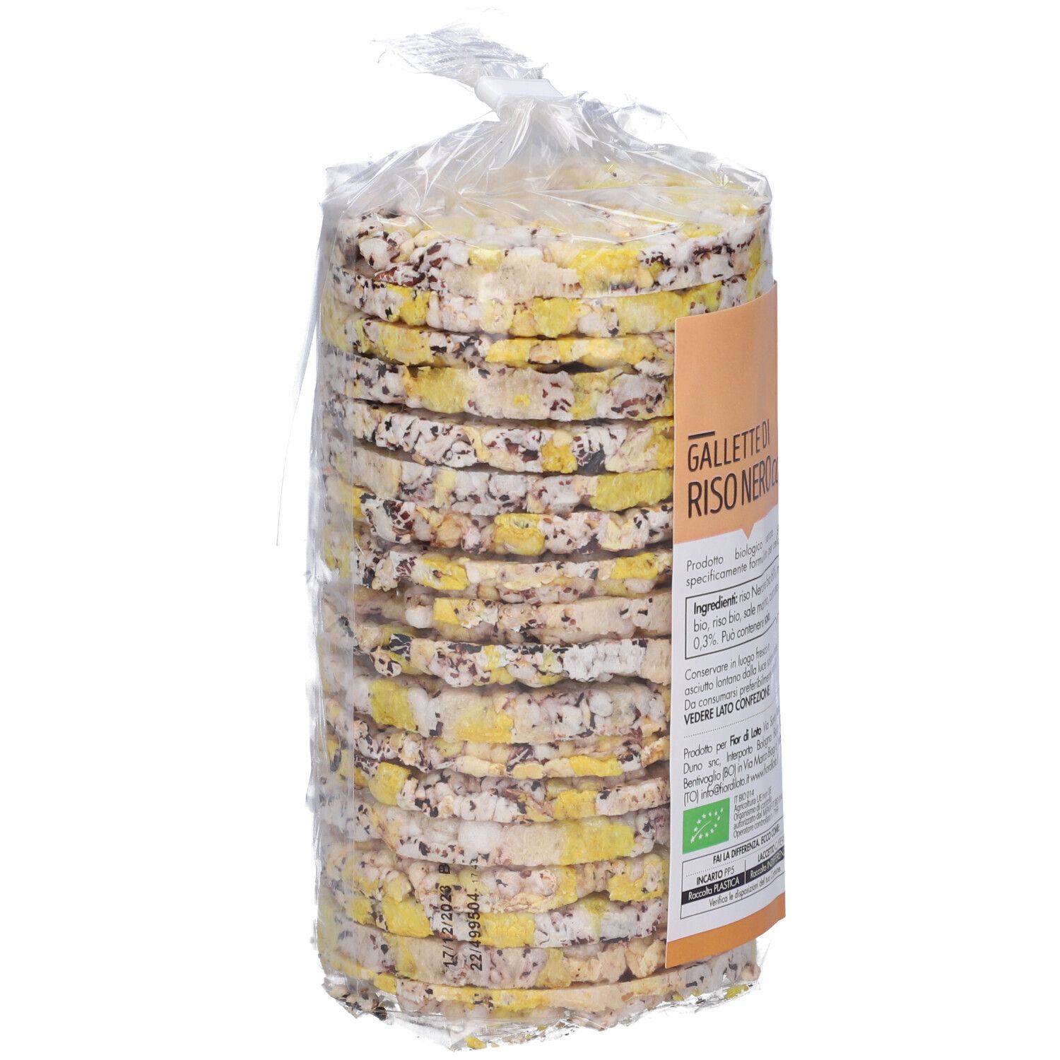 Confezione cilindrica di gallette di riso con curcuma. Imballaggio trasparente. Visibili: punti gialli e scuri. Senza testo.