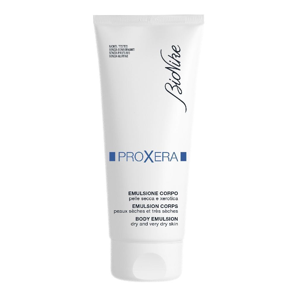 Tubo bianco con testo blu. Scritta: Bionike, Proxera, Emulsione Corpo, per pelli secche.