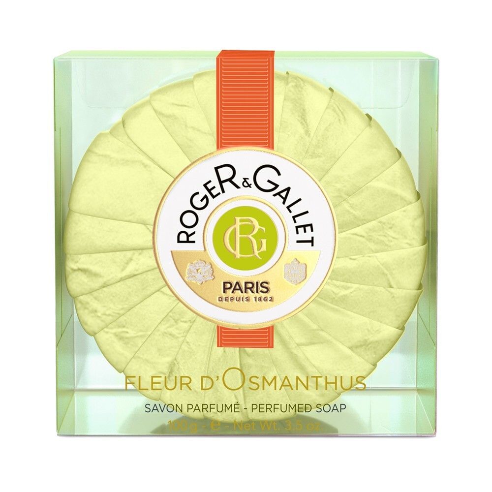 Runde Seife in transparenter Box. Gelbe Seife, orangefarbenes Band. Logo: Roger & Gallet, Paris. Fleur d'Osmanthus.
