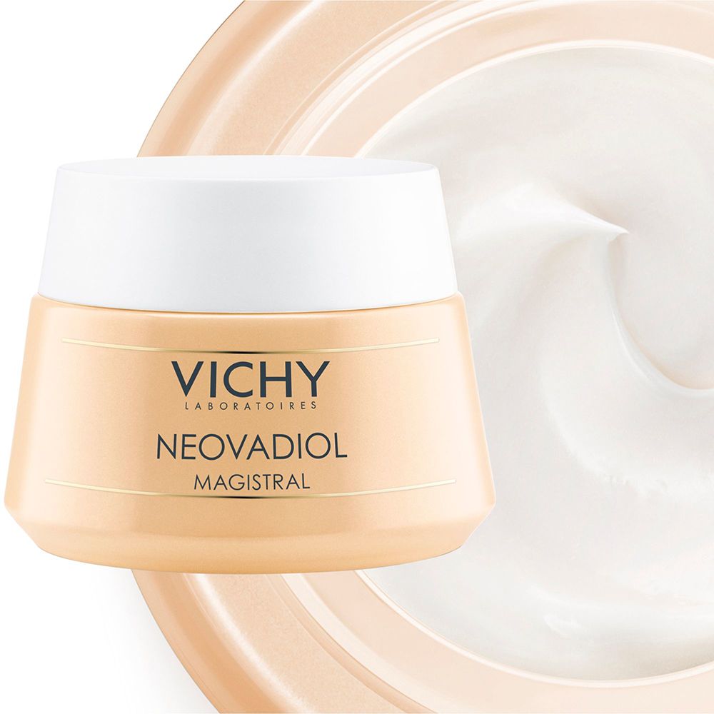 Cremebehälter mit weißem Deckel. Aufschrift: VICHY, NEOVADIOL MAGISTRAL. Creme-Textur im Hintergrund.