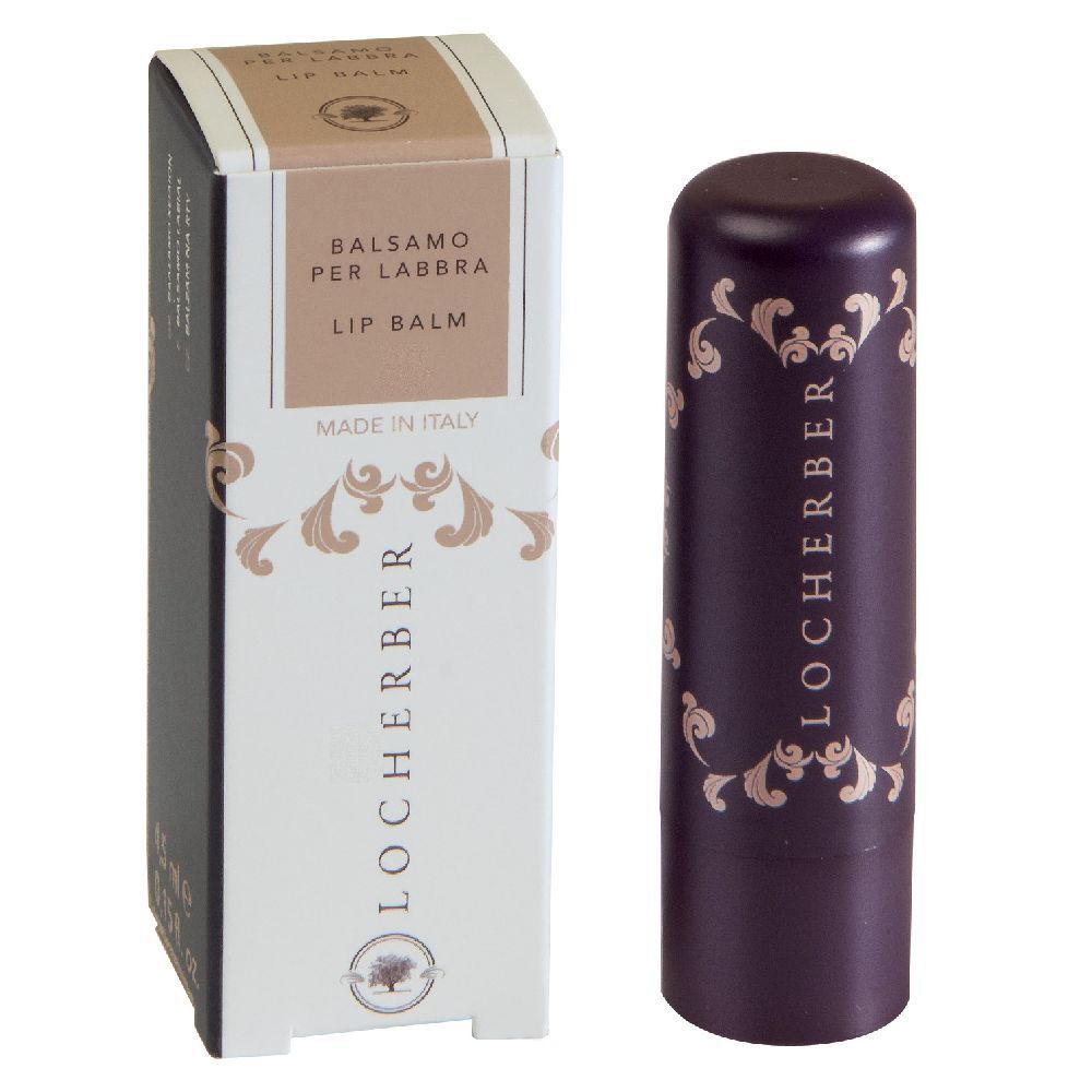 Balsamo per labbra e confezione. Astuccio viola scuro con motivi dorati e logo. Scatola con informazioni sul prodotto.