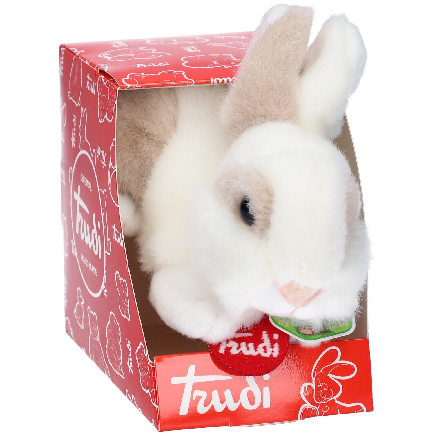 Coniglio di peluche bianco e marrone in scatola rossa. Sulla scatola c'è scritto "Trudi".