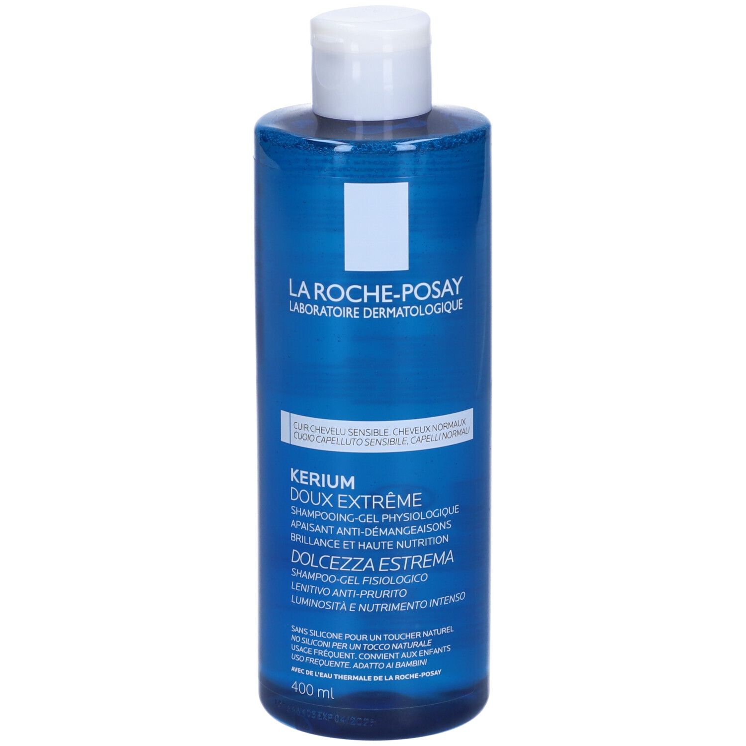 Flacone blu con tappo bianco. Scritta: Kerium Doux Extreme, Shampooing-Gel Physiologique. Per capelli sensibili.