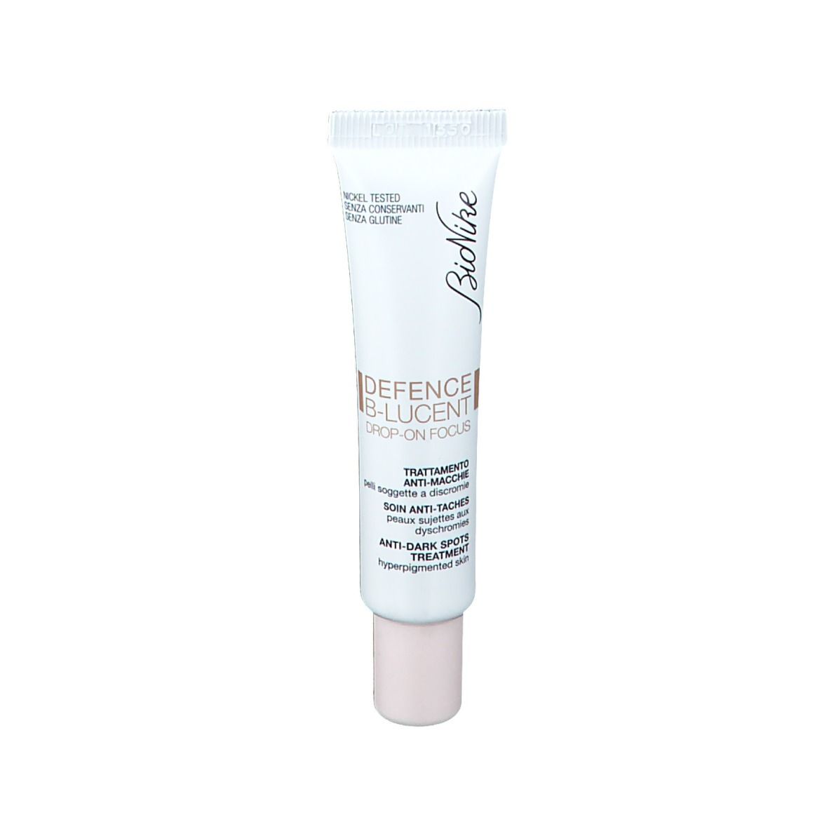 Tube blanc avec inscriptions marron et blanches. Nom du produit et marque visibles. Bouchon beige.