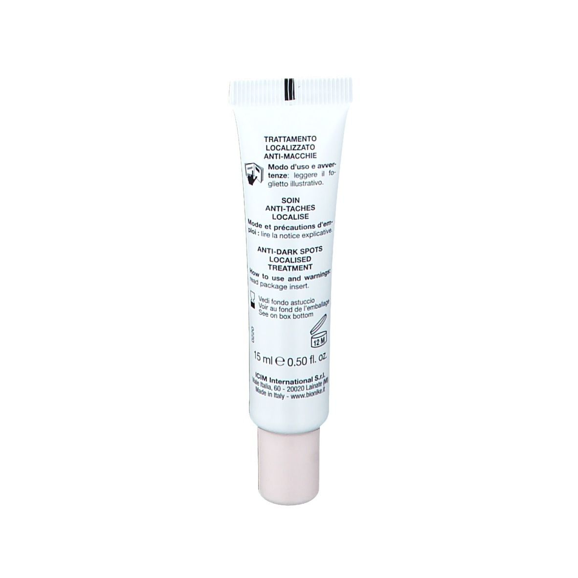 Petit tube blanc avec inscriptions. Nom du produit et marque visibles. Bouchon beige. Texte au dos.