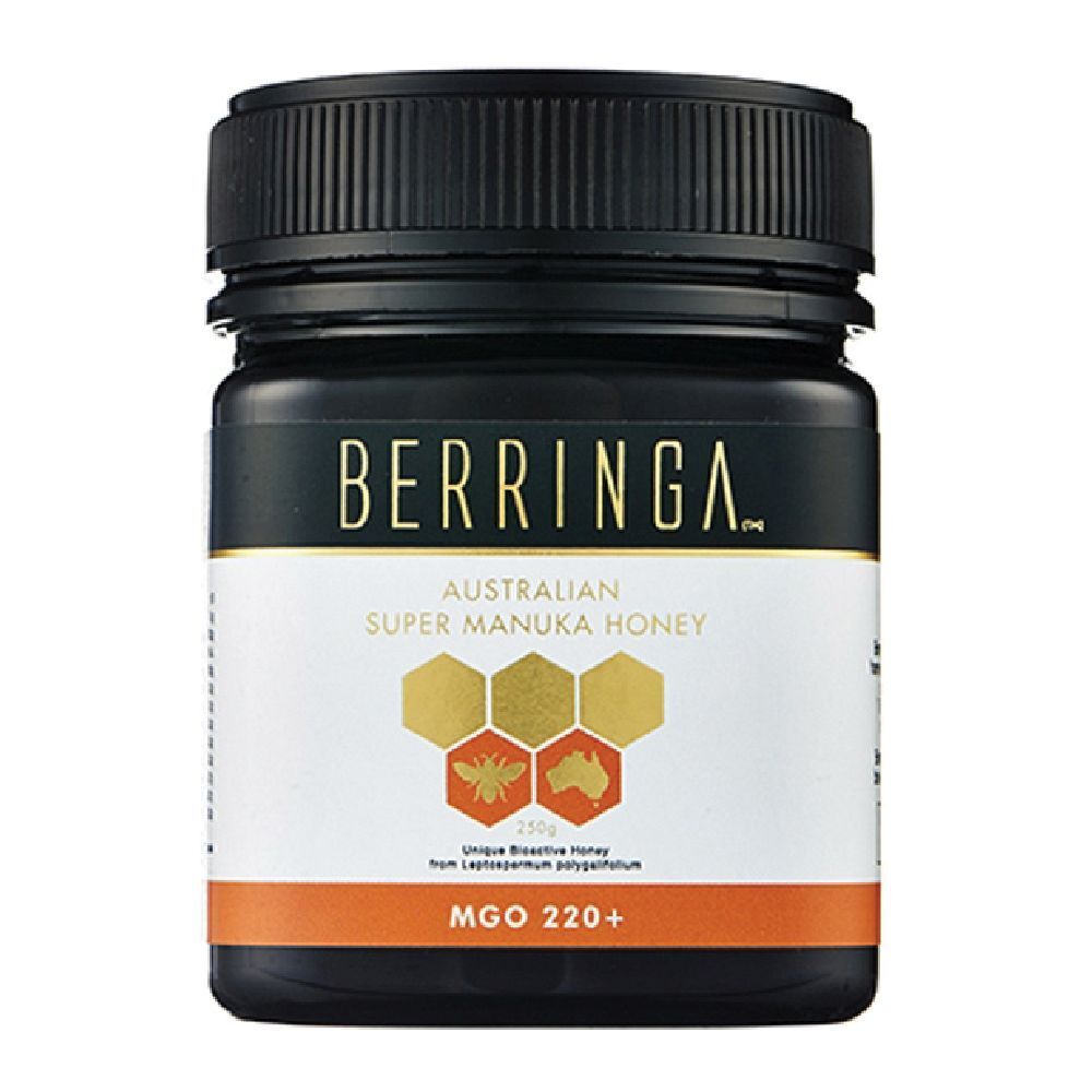 Barattolo nero di miele. Scritta BERRINGA, Australian Super Manuka Honey, 220 MGO. Grafica a nido d'ape.