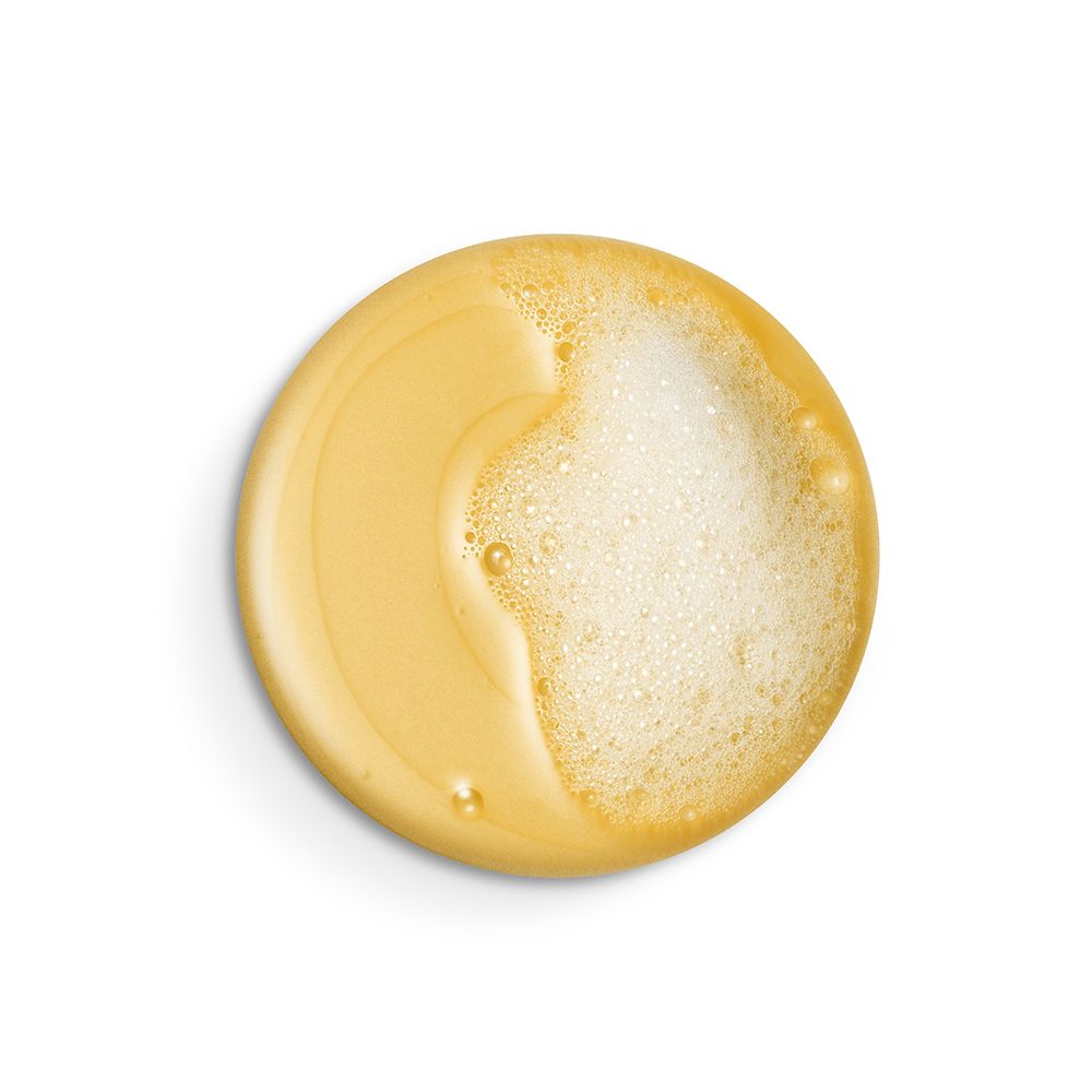 Liquido giallastro con schiuma. Forma rotonda, vista dall'alto.