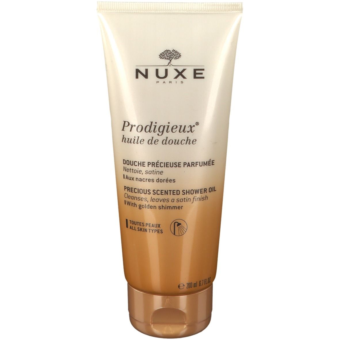 Beige Tube mit goldfarbenem Boden. Aufschrift: NUXE, Prodigieux huile de douche. Text in Französisch und Englisch. Für alle Hauttypen.