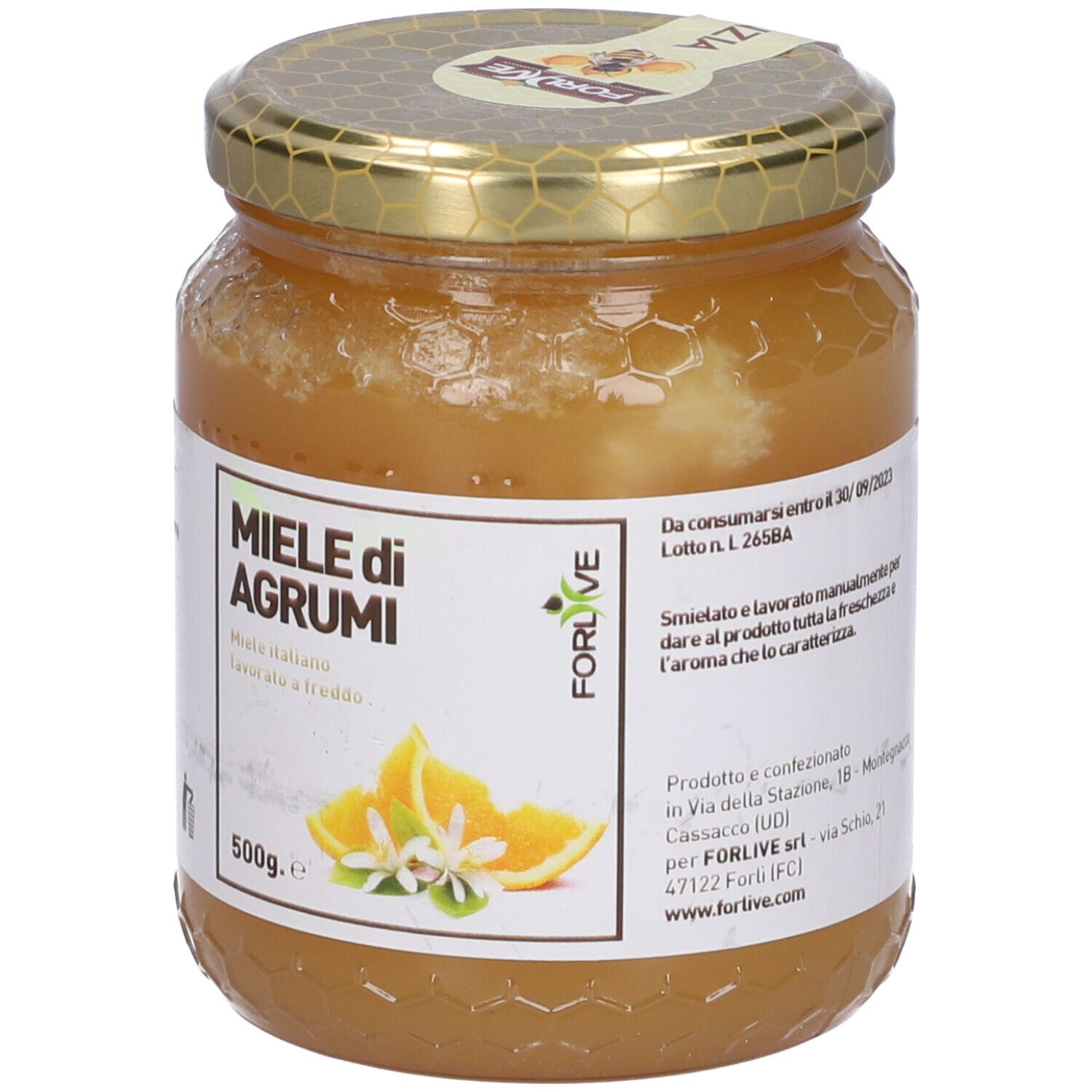 Vasetto di miele. Etichetta con "Miele di Agrumi" e illustrazione di arance. Coperchio dorato.