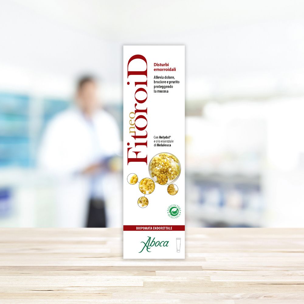 Produktverpackung neo FitoroiD auf einem Tisch. Im Hintergrund eine Person in einem weißen Kittel.